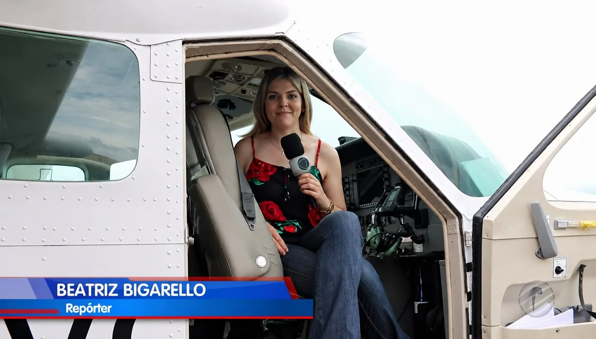 Beatriz Bigarello realizando uma reportagem dentro de uma aeronave